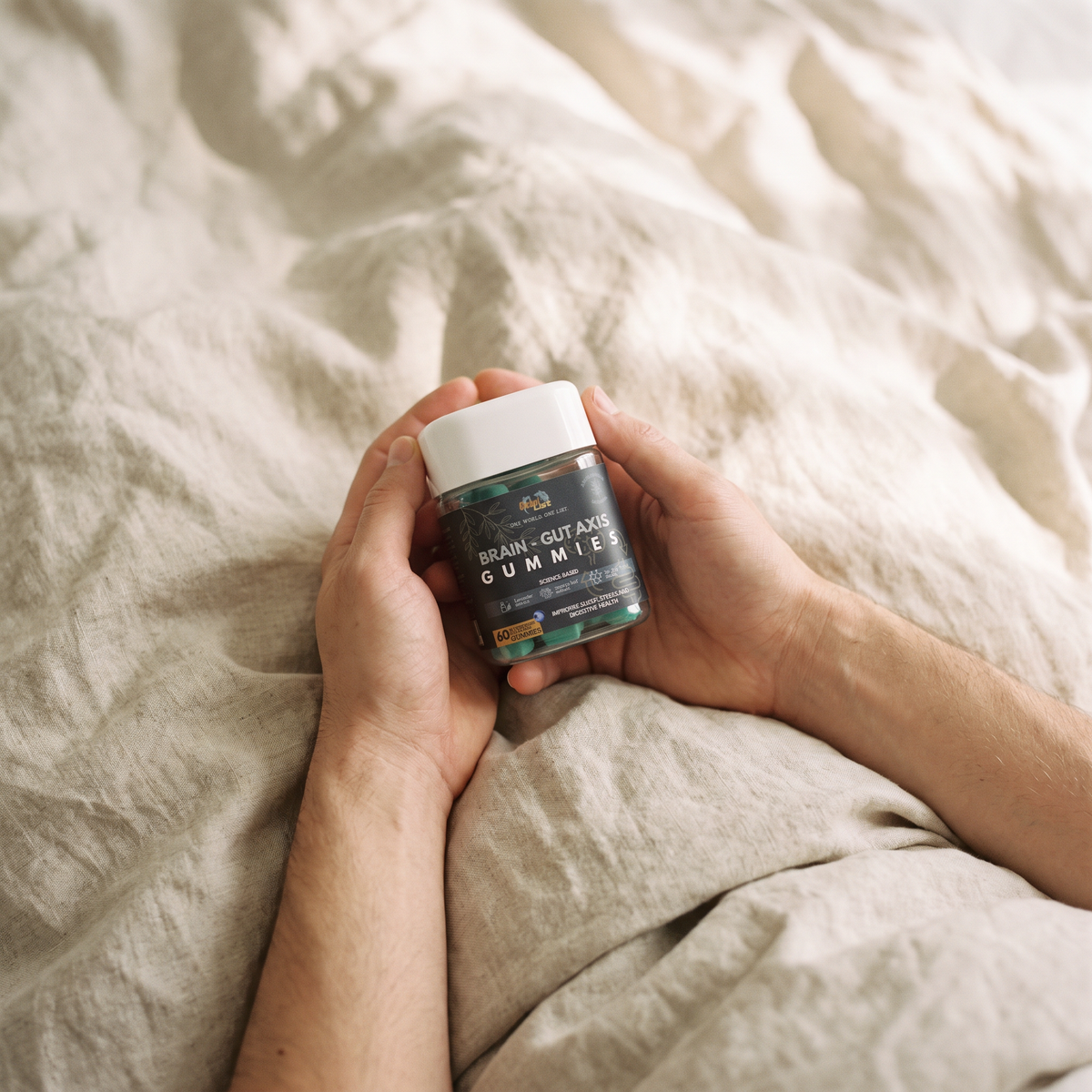 Hands holding the jar on linen bedding