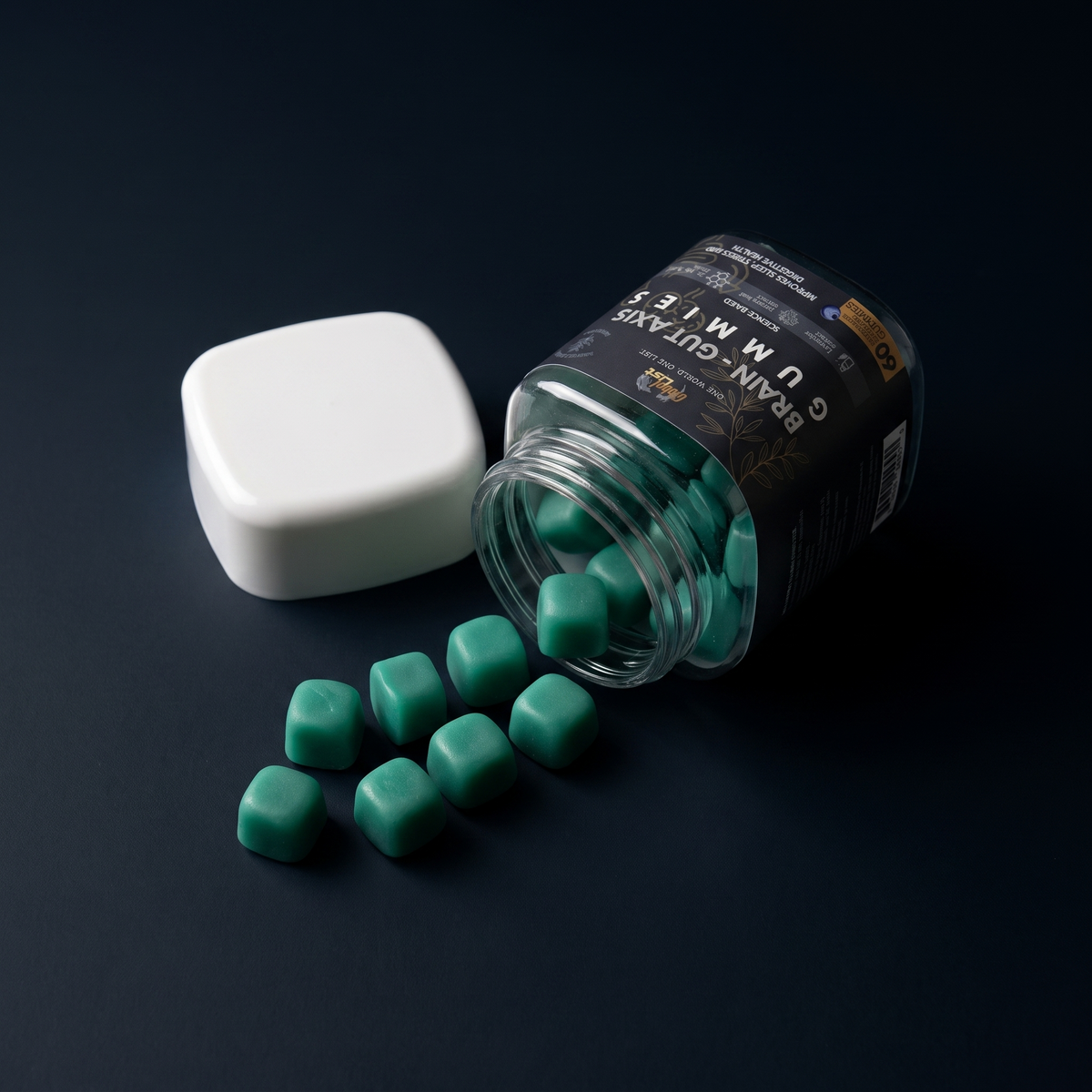 Open jar on its side with teal gummies spilling onto a dark surface